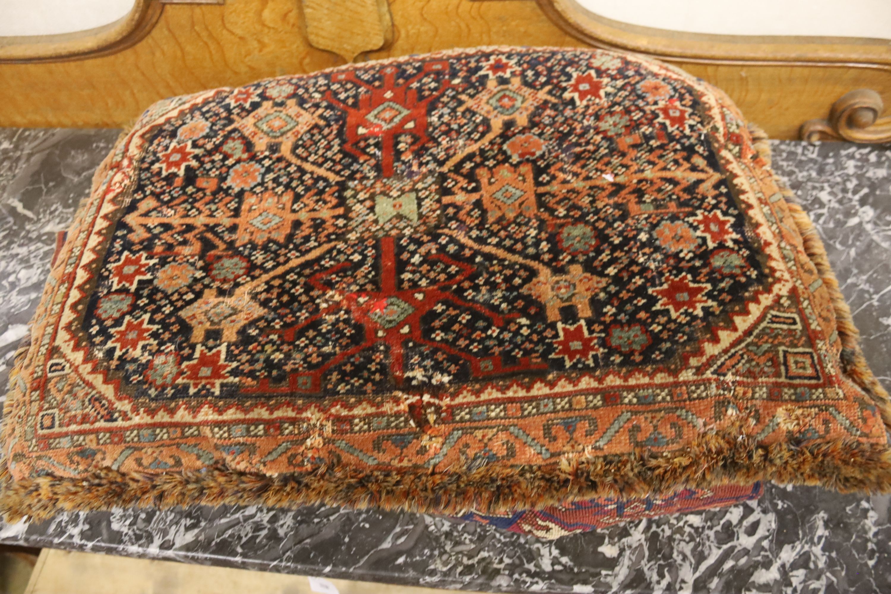 Three Bokhara rugs, four kilim-faced cushions and a small saddlebag, largest 74 x 50cm